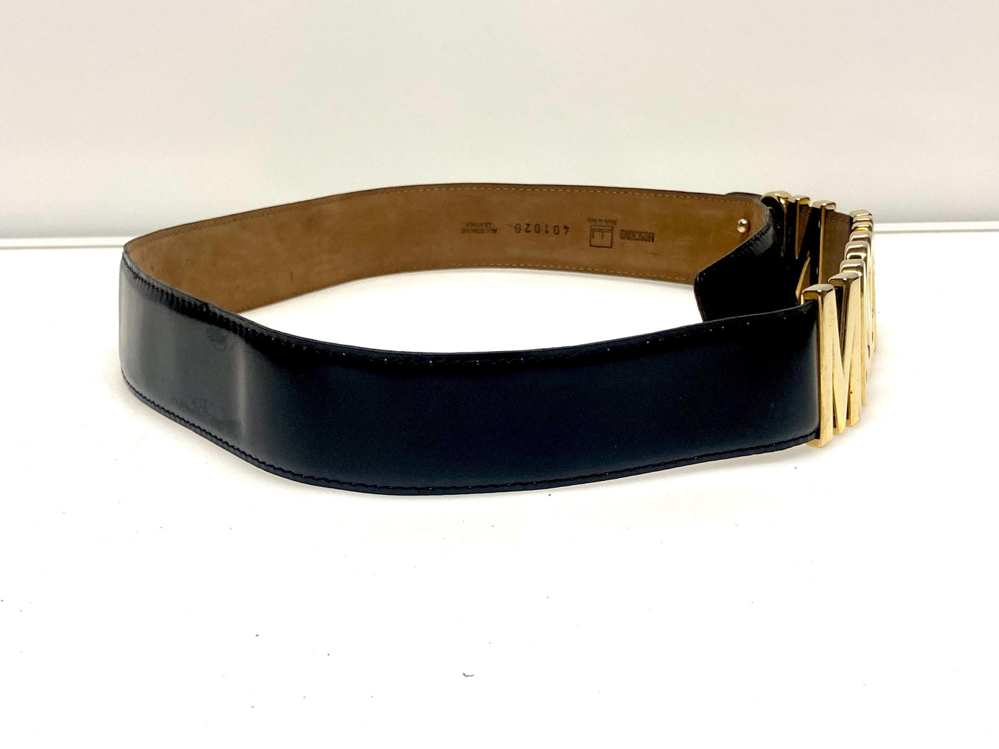 Moschino 90s vintage womens dress belt in black genuine leather. Iconic individual golden moving letters logo. Made in Italy. 80s. NOS