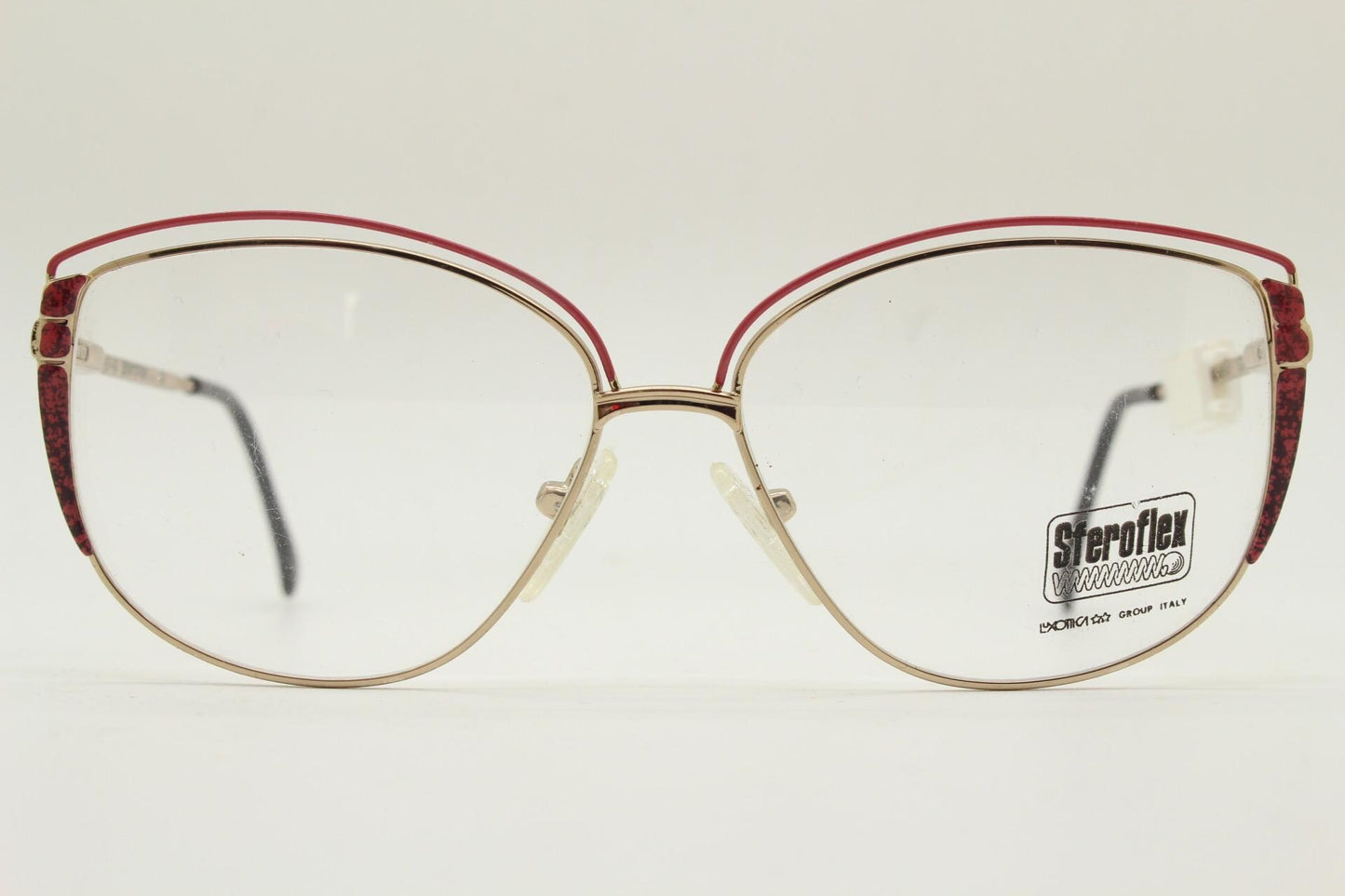 Luxottica 80s vintage gold metal eye glasses made in Italy. Inventive double brow with red highlights. Optical frame. Prescription NOS