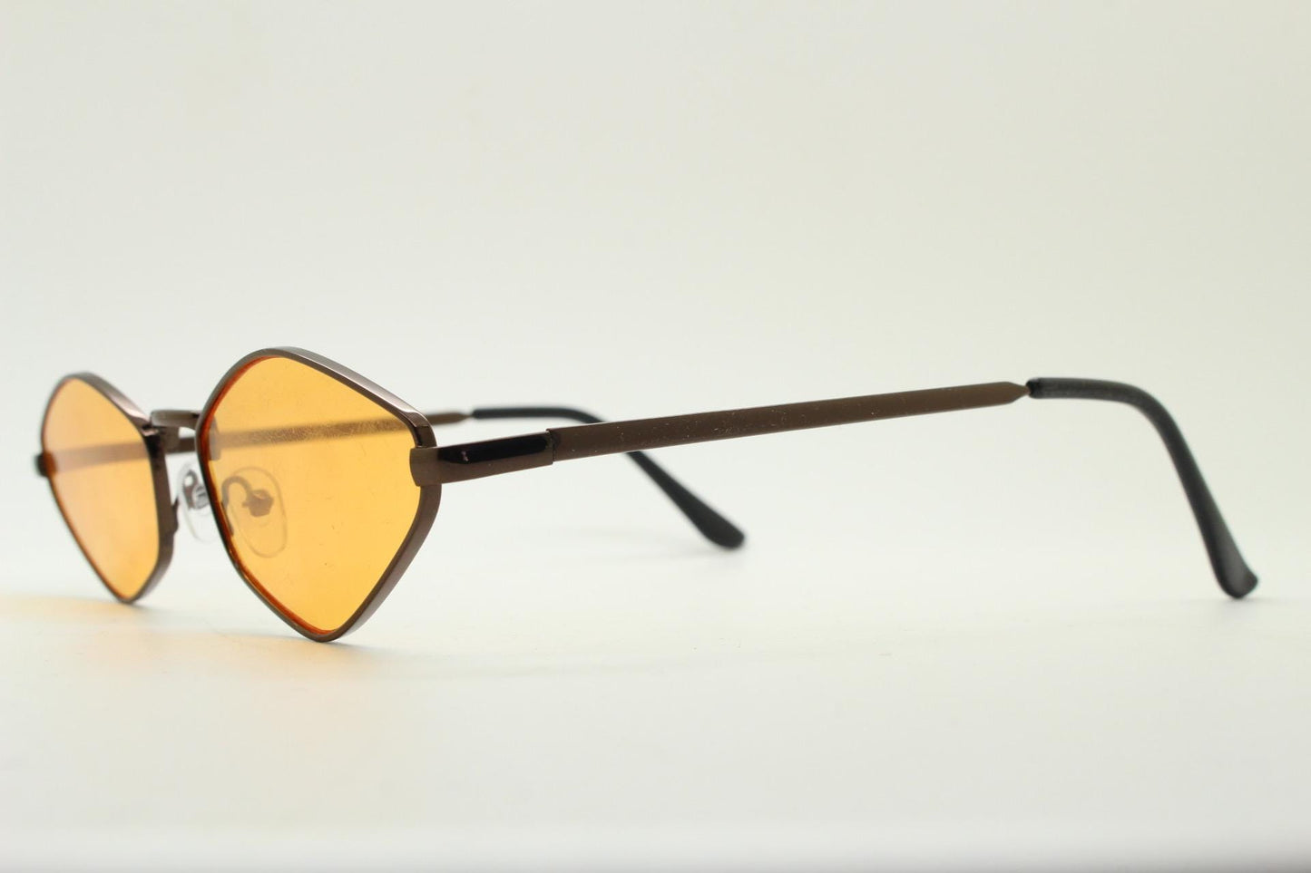 90s vintage pointed hexagon sunglasses. Minimal bronze brown psychedelic mod style frame with blazing orange lenses. Unused NOS