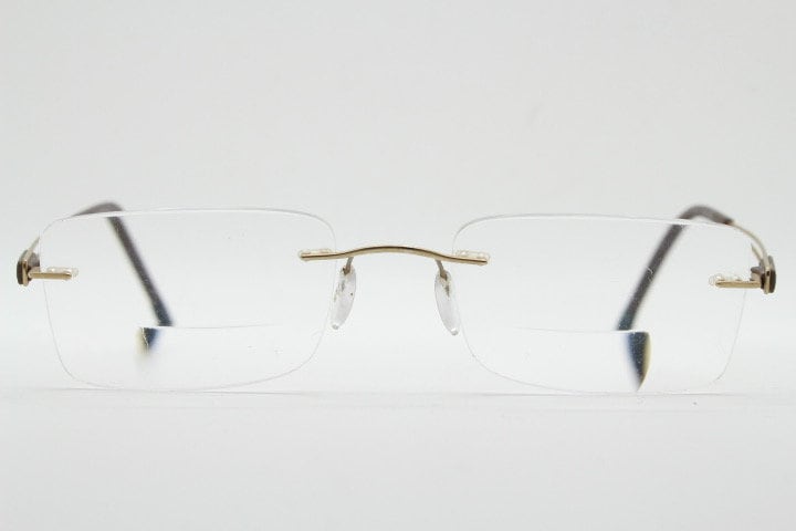 Silhouette rectangular frameless eye glasses model 7677 made in Austria. Minimal lightweight optical frame with golden trim. Prescription RX