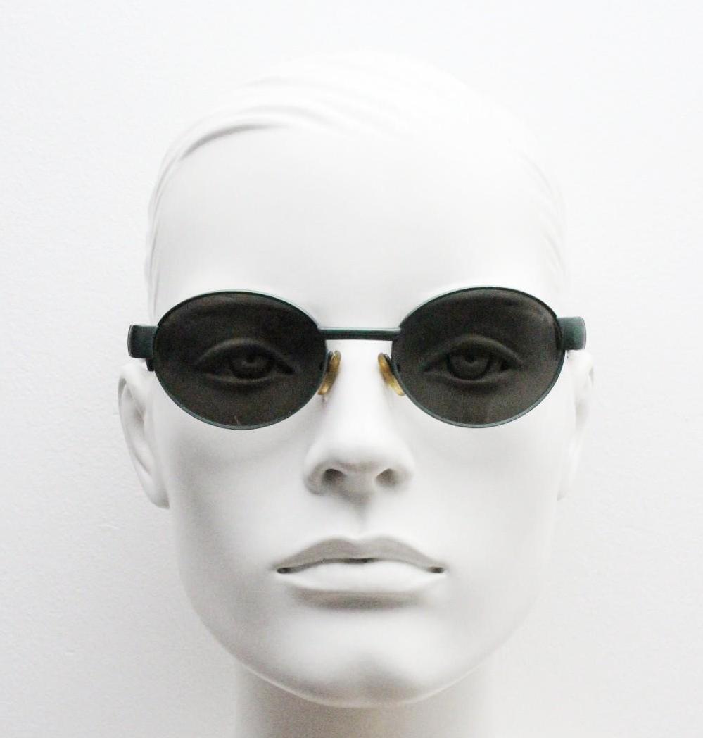 Safilo for Oxydo 90s vintage oval sunglasses made in Italy. Green matt finish solid metal frame with black arms and green lenses. Unused NOS