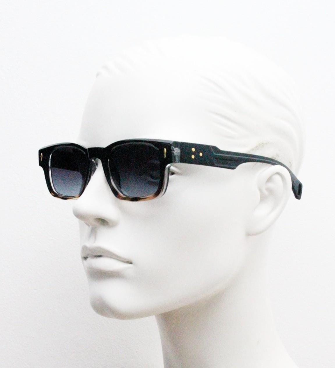 Vintage 90s low profile thick frame sunglasses. Black and tortoise ombre frame with graduating grey lenses. Unused NOS. One off sample