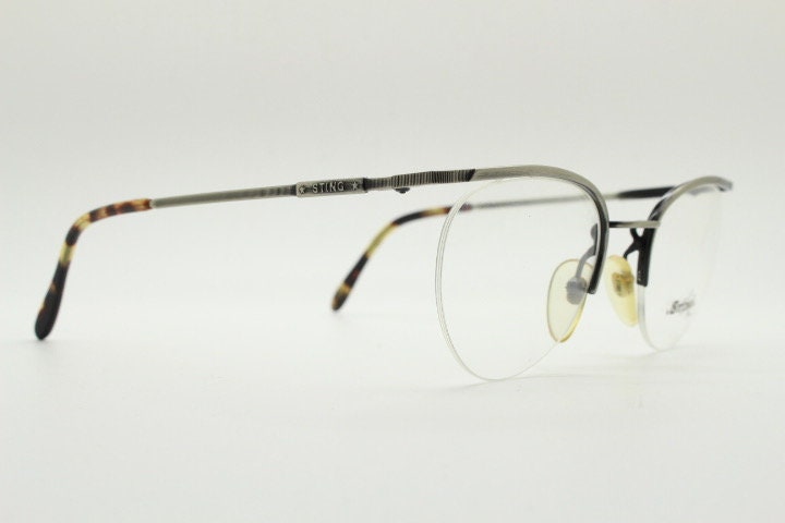 Sting 90s vintage round eye glasses. Minimal pewter finish metal half frame brow line optical frames. Prescription eyeglasses. RX. NOS