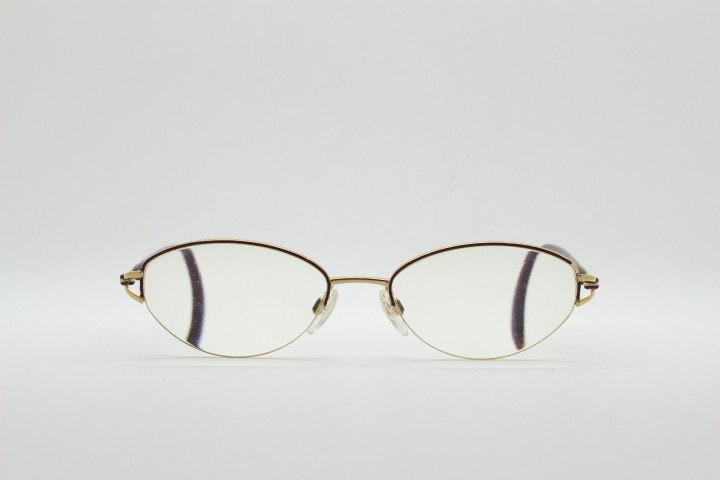 Silhouette oval half frame eye glasses model 6566 made in Austria. Minimal optical frame with gold trim deep purple arms. Prescription RX
