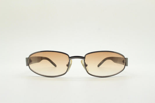 90s vintage oval sunglasses small bug eye with light tone lenses. Satin finish brown metal frame with black arms. 2000's. NOS
