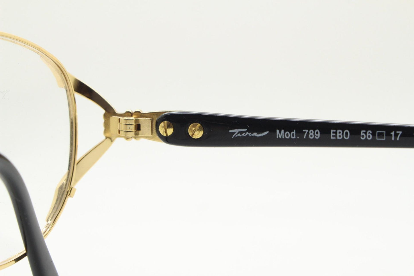 Tura 80s vintage oval eye glasses made in Italy. Womens black and gold optical frame with Y forked temples. Prescription RX. Unused NOS