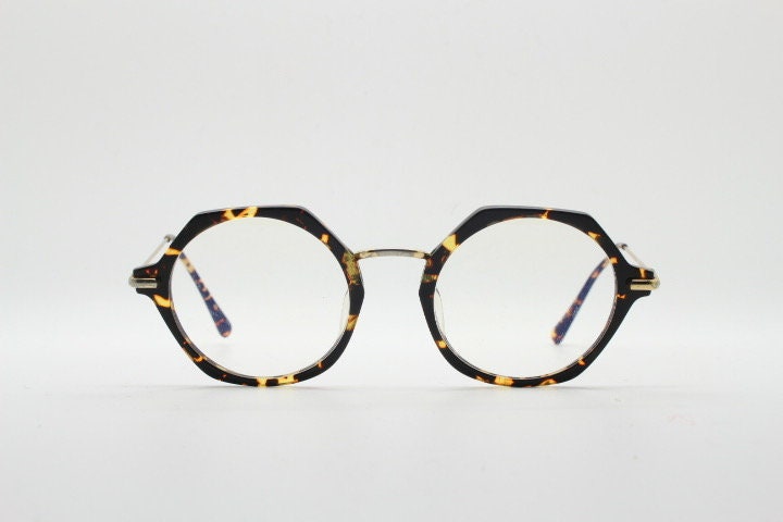 Kaleos hexagon eye glasses model Trevethyn made in Italy. Amber tortoise acetate optical frames with gold arms. Prescription eyeglasses. RX