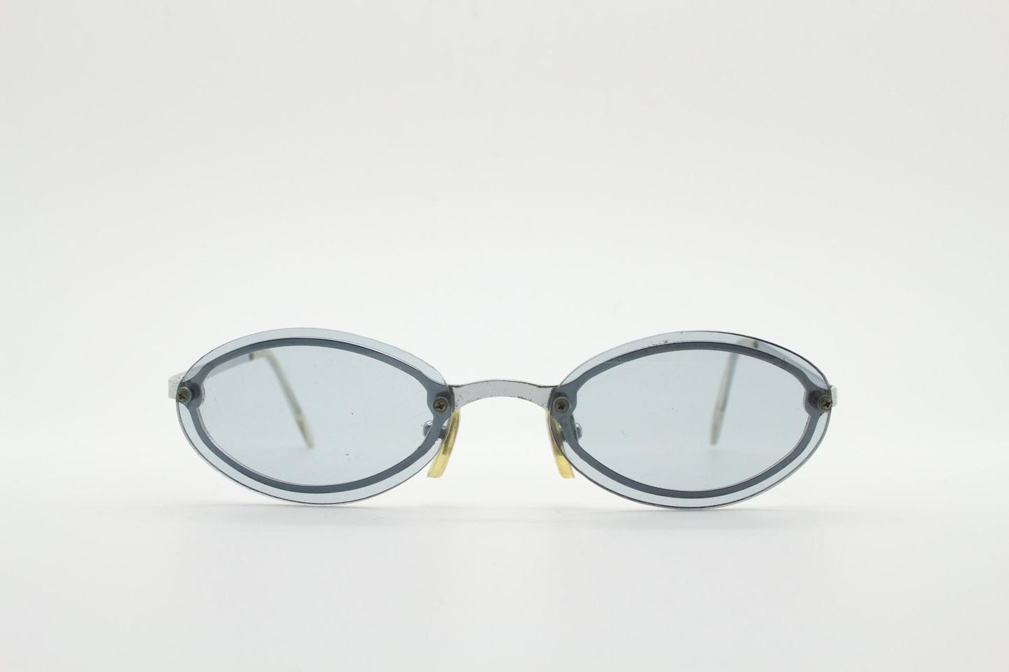 90s vintage small oval sunglasses. Minimal silver chrome metal frame with overlapping light tone grey lenses. Micro. Steampunk