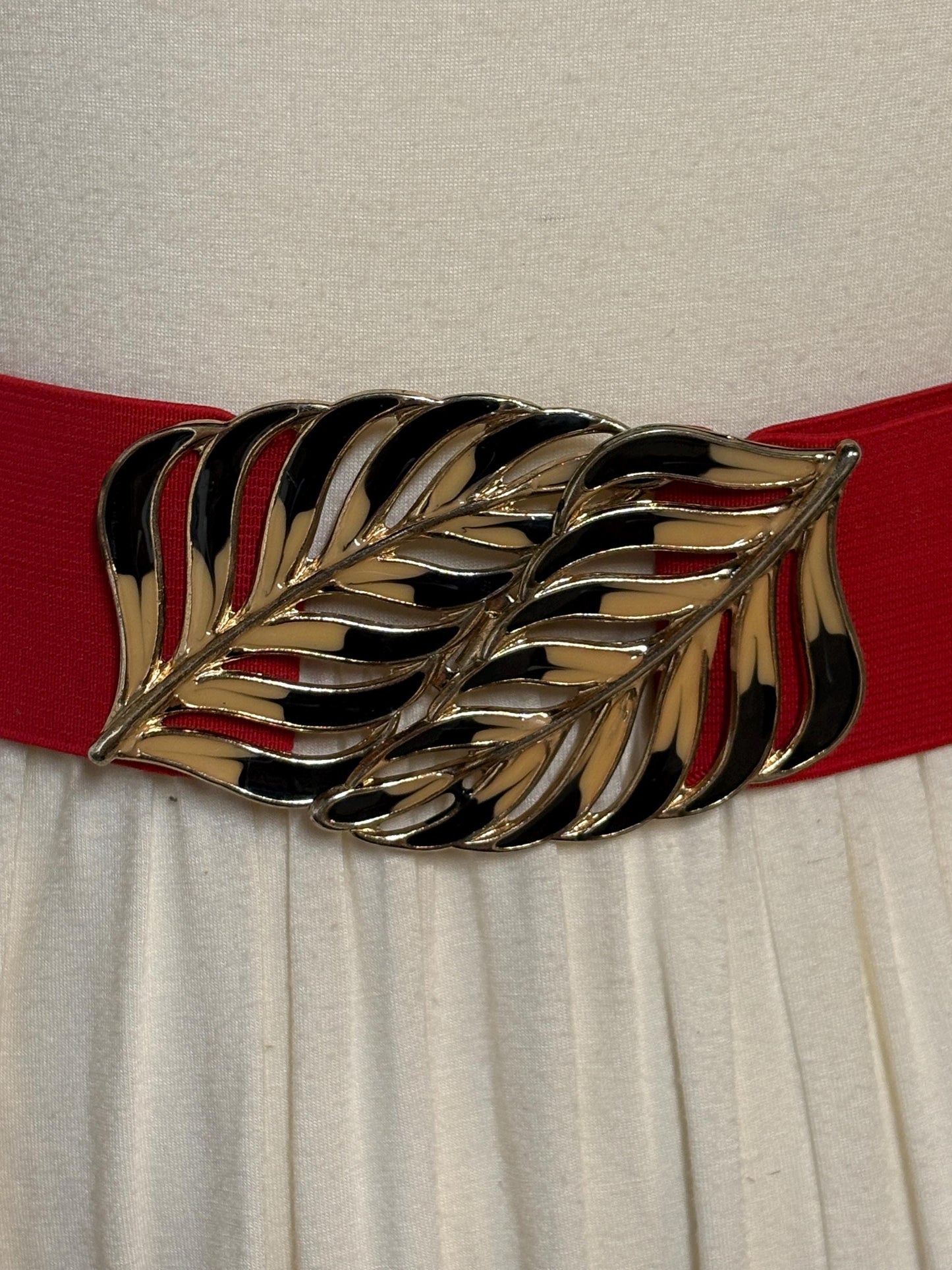 80s vintage womens elastic tall belt. Large exotic palm leaf buckle. Flattering cinch effect. Extensive adjustable size range. Unused NOS