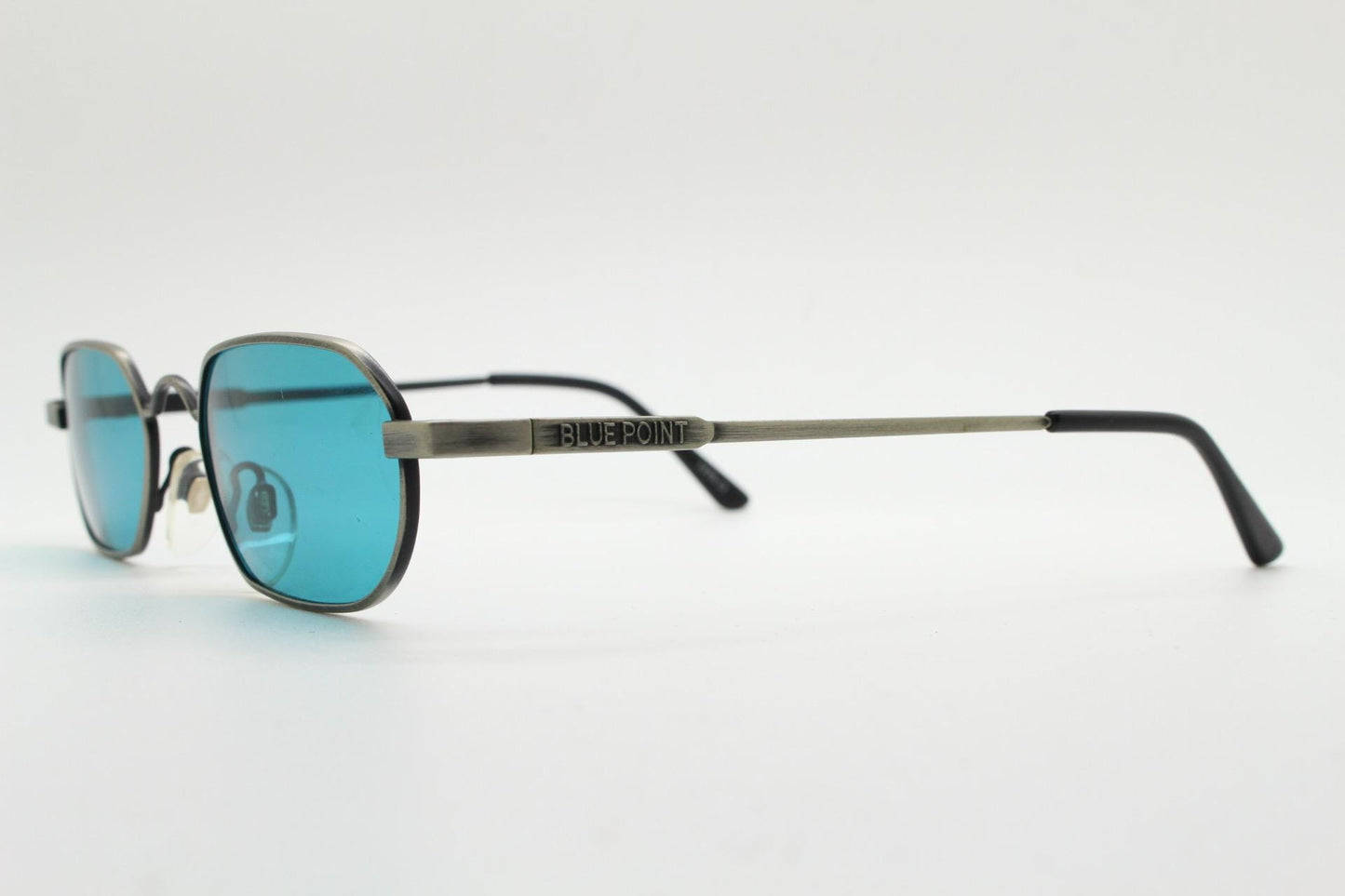 90s vintage small angular oval sunglasses by Blue Point. Low profile brushed bronze finish metal frame with turquoise blue lenses, NOS