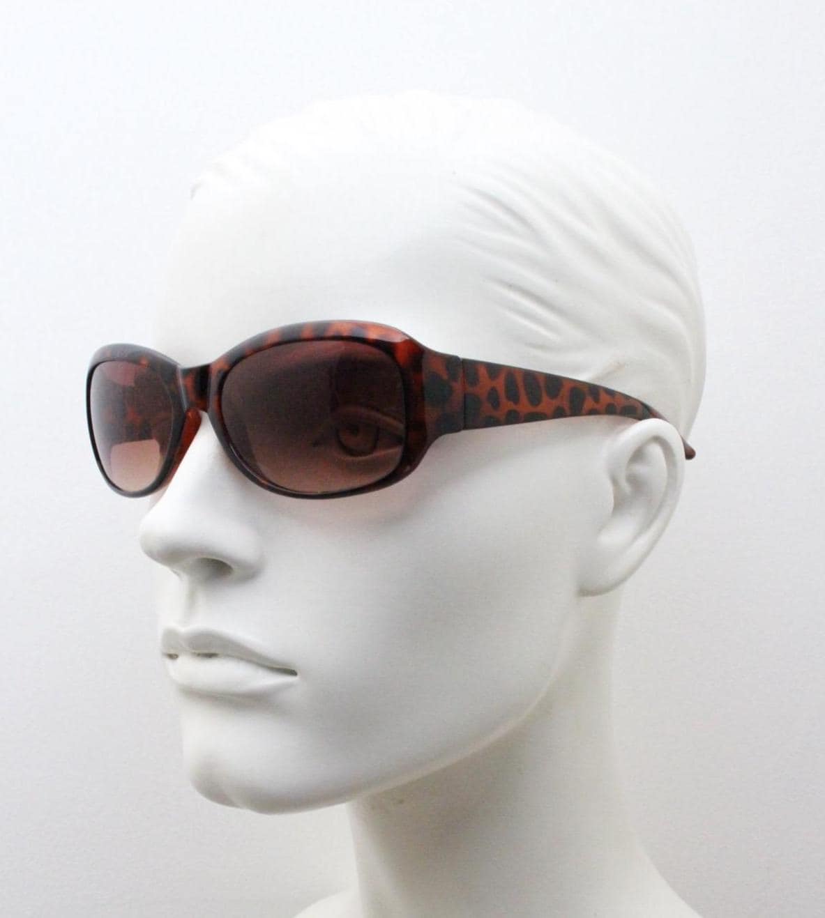 Y2k vintage wrap around bug eye sunglasses. Curved tortoise gloss frame with gradient Havana brown lenses. 2000's NOS